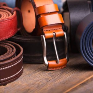 Leather colored belts on a wooden table